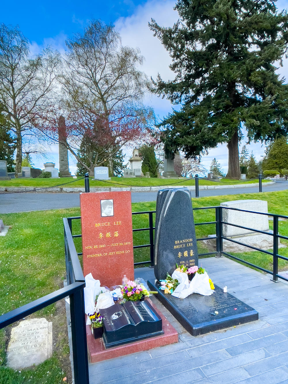 Bruce Lee's red headstone next to Brandon Lee's black one